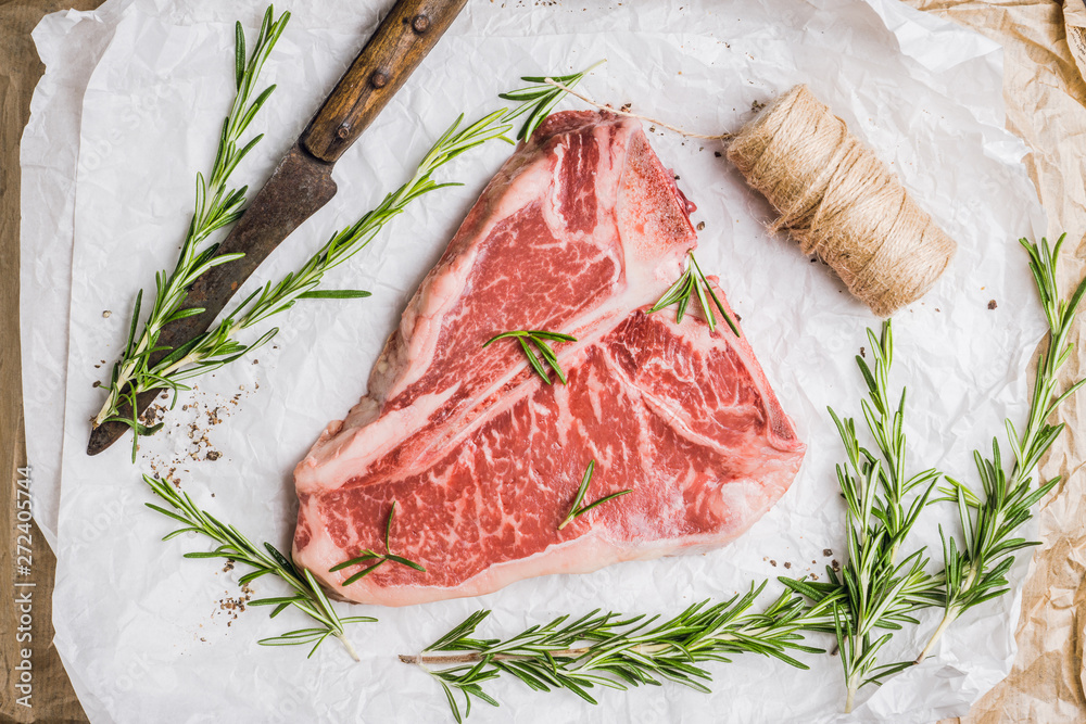Raw fresh marble T-bone meat on the rustic background. Selective focus. Shallow depth of field. Raw fresh marble T-bone meat on the rustic background. Selective focus. Shallow depth of field.