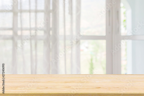 Empty wood table top with window curtain abstract blur background for product display