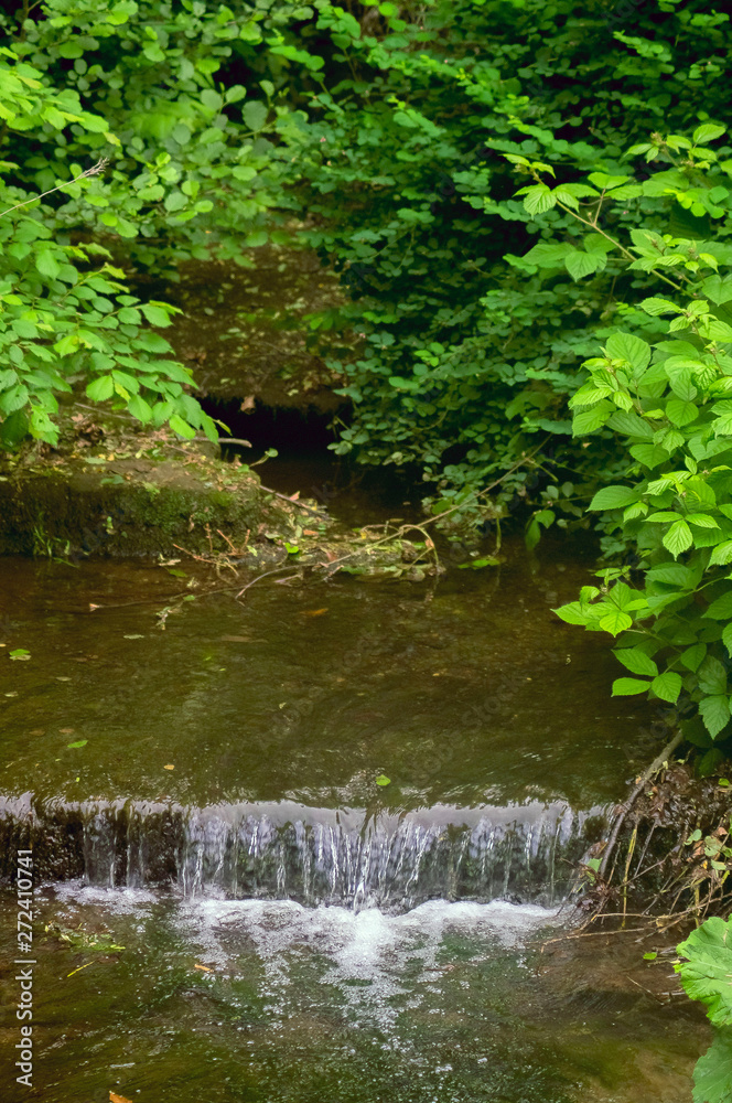 A small river with a waterfall. A small river with a waterfall.