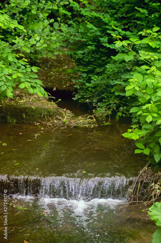 A small river with a waterfall.