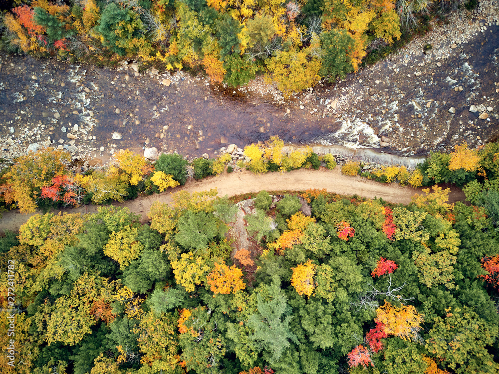 Swift river landscape at autumn in New Hampshire, USA. Fall in New England. Aerial drone shot.