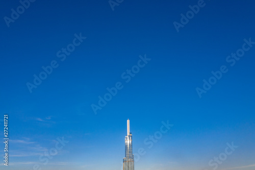 Fototapeta Naklejka Na Ścianę i Meble -  Top View of Building in a City - Aerial view Skyscrapers flying by drone of Ho Chi Mi City with development buildings, transportation, energy power infrastructure. include Landmark 81 building 