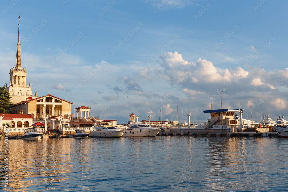 small motor boats of various sizes in a quiet harbor in the seaport of the city of Sochi, Russia