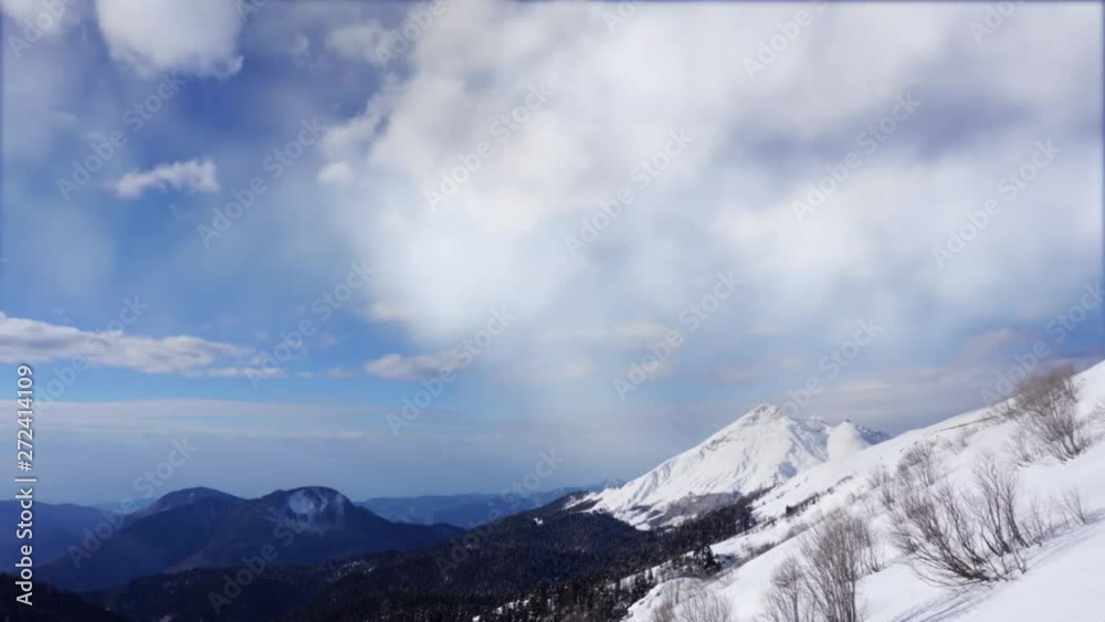 White clouds flying high over Caucasus mountain landscape fade-in. Can be used for opening credits, titles. Time lapse. White clouds flying high over Caucasus mountain landscape fade-in. Can be used for opening credits, titles. Time lapse.