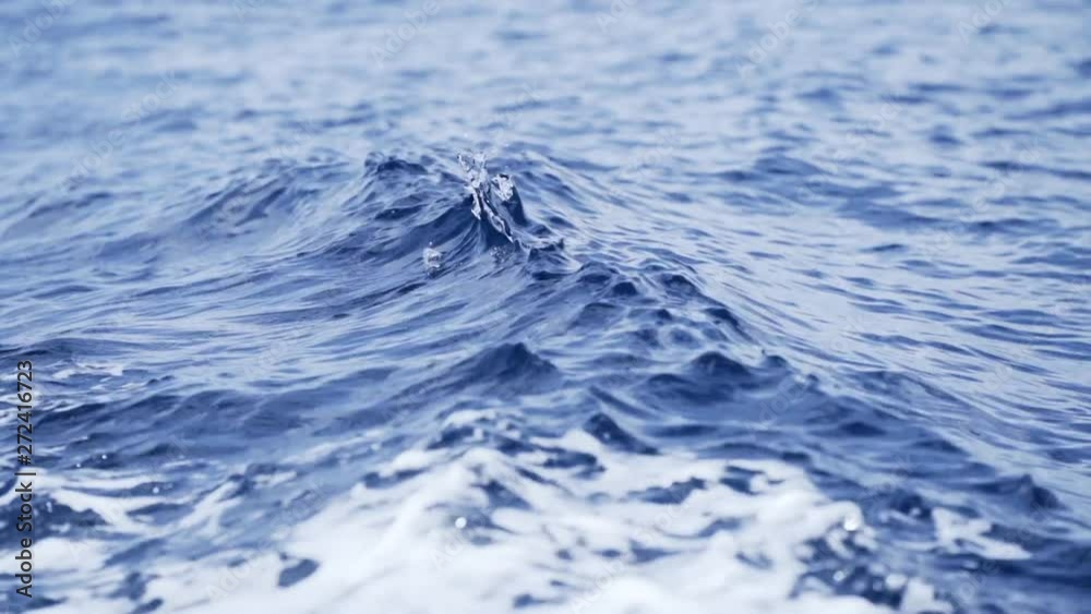 Wake waves close up as boat travels through blue ocean waters Wake waves close up as boat travels through blue ocean waters