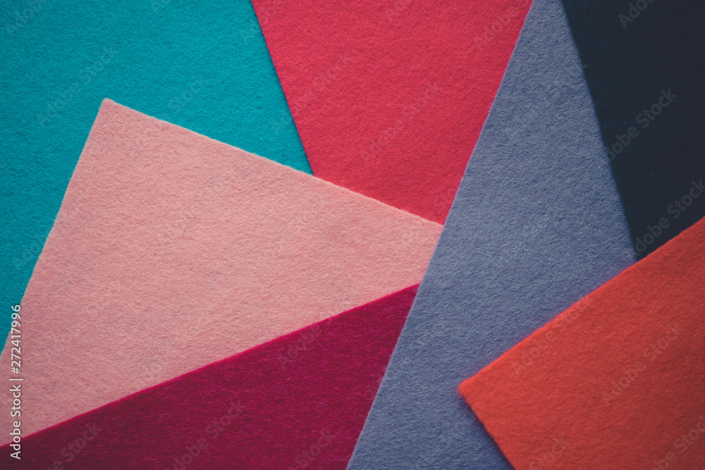 Fototapeta premium Felt color textile. Samples of soft felt flaps in different colours. Fan of colored bright textile material. Felt craft abstract handicraft background for handmade and creative