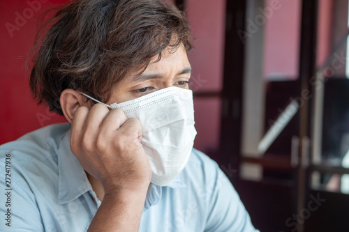 sad man wearing air filter mask in unhealthy, danger, polluted air environment