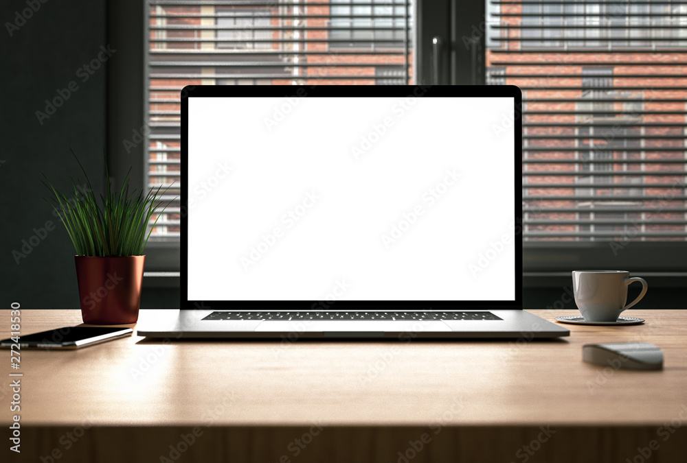 Laptop with blank screen on wooden desk in bright modern home interior