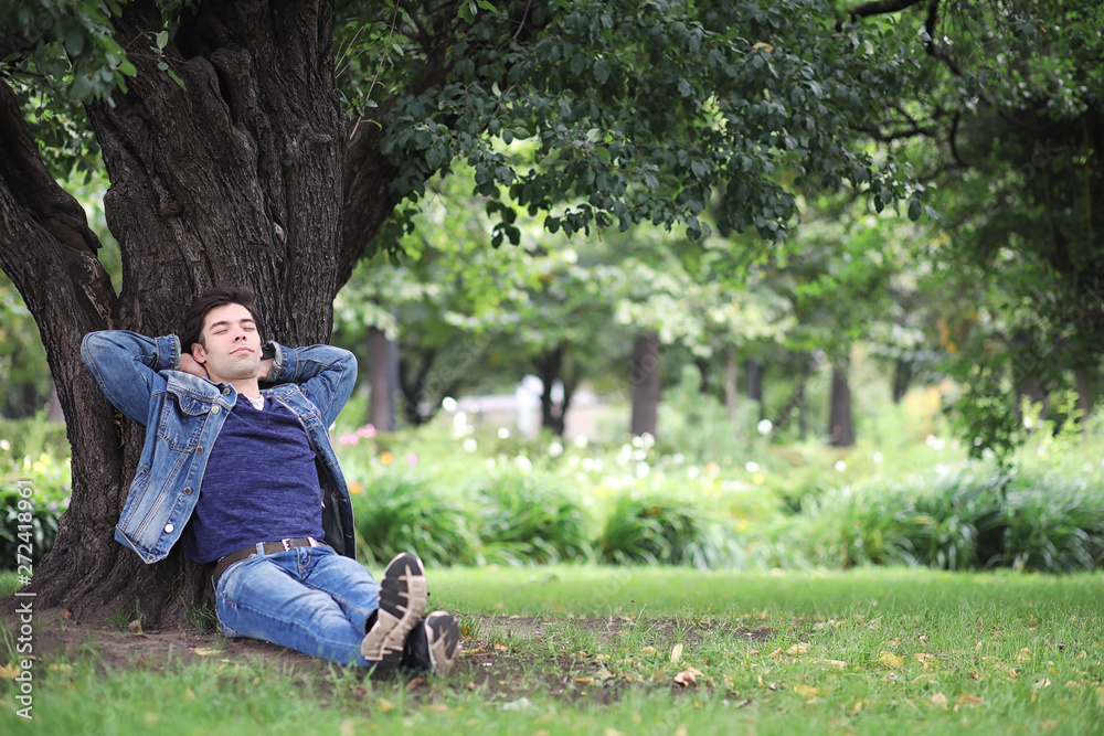 A young man walks in the park at lunch time. A man is on a walk in the city. A student in the park. A young man walks in the park at lunch time. A man is on a walk in the city. A student in the park.