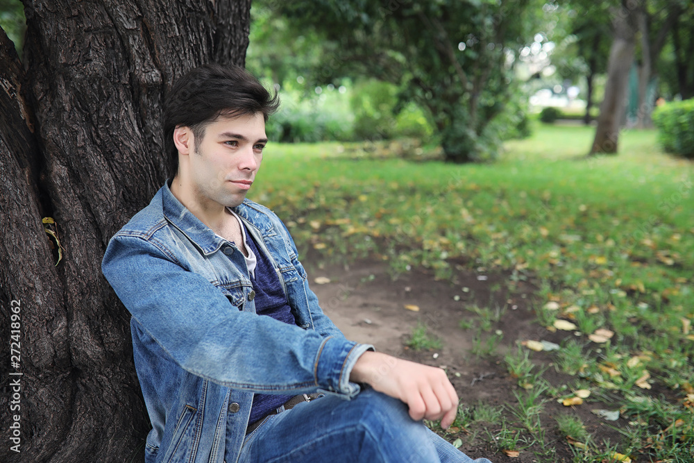A young man walks in the park at lunch time. A man is on a walk in the city. A student in the park. A young man walks in the park at lunch time. A man is on a walk in the city. A student in the park.