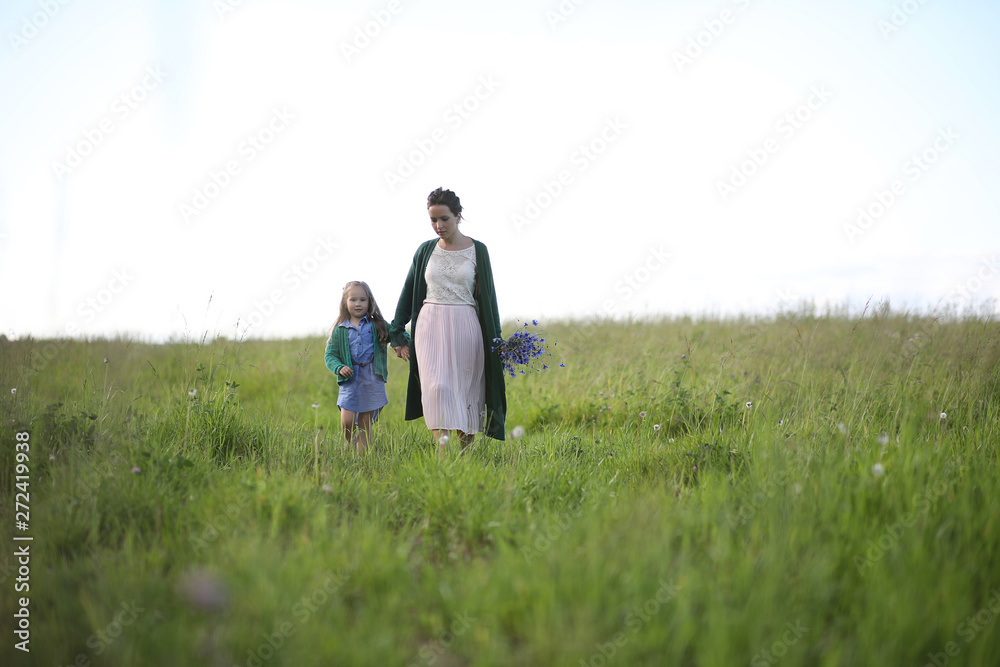 Mother with daughter walking on a road Mother with daughter walking on a road
