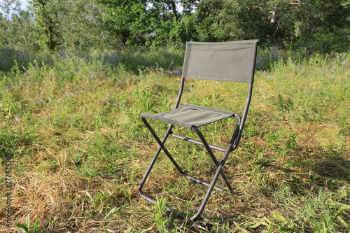 folding tourist chair on meadow