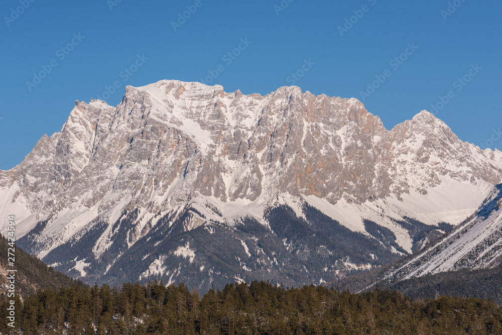 Germany highest mountain the Zugspitze..In winter, the mountain is full of beauty, with many trees in the valley and snow on top of the mountain.