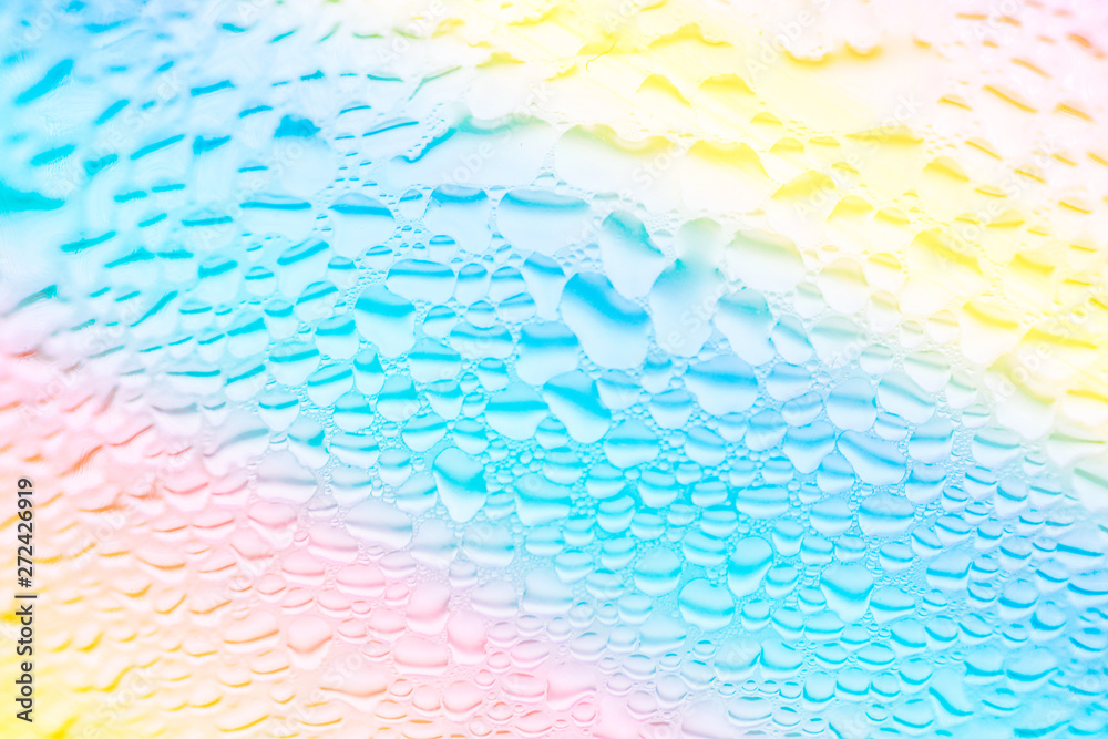 Trendy liquid texture background. Transparent water rain drops patterns on glass. Gradient rainbow pastel colors. Abstract backdrop. Template for design. Technology nature environment concept