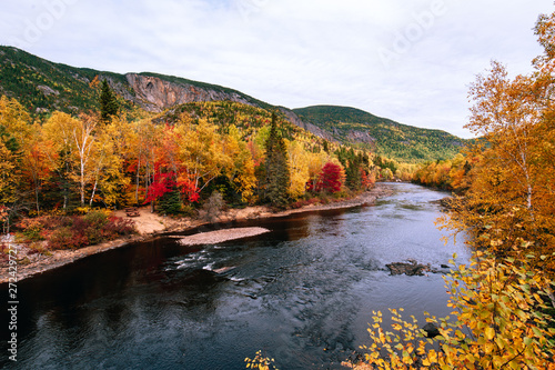 Empty road in the Regional Park of Hautes-Gorges of the Malbaie River at autumn time