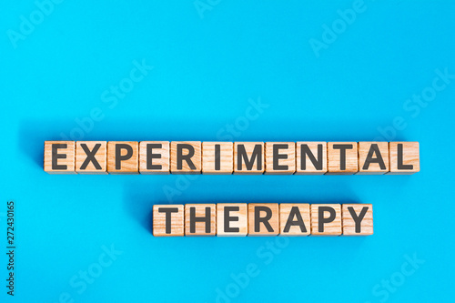 experimental therapy inscription wooden cubes with letters on  blue background