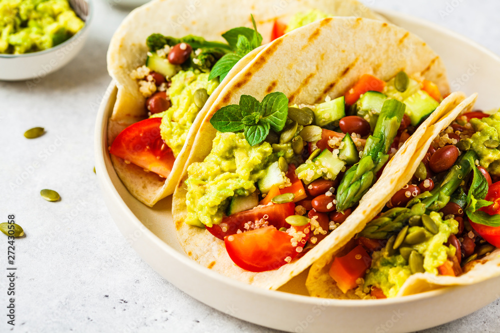 Vegan tortillas with quinoa, asparagus, beans, vegetables and guacamole. Vegan tortillas with quinoa, asparagus, beans, vegetables and guacamole.