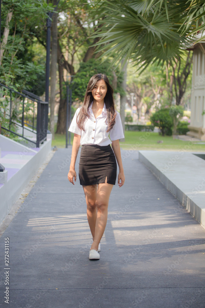 Obraz premium Portrait of thai adult student university uniform beautiful girl relax and smile