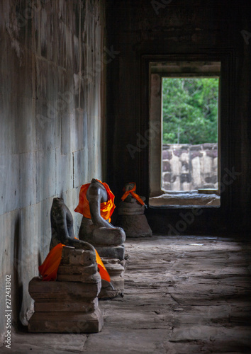 Headless stone buddha statues inside the Angkor wat temple complex, Siem Reap Province, Angkor, Cambodia photo