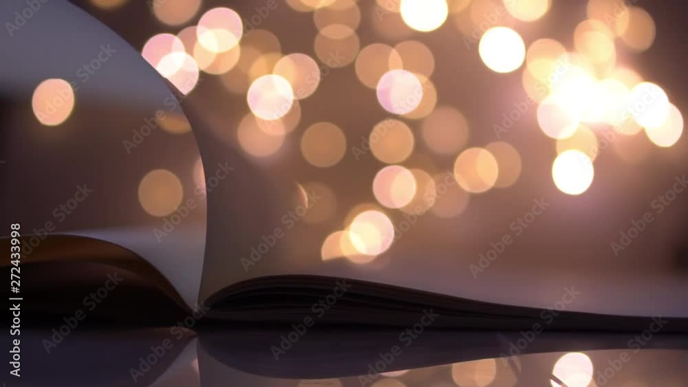 flipping and opening the book page on colorful light blurred bokeh for education, reading, knowledge, fiction, fairy concept background