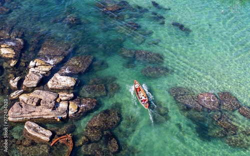 Boat crossing the sea near the rocks in Vietnam, Phu Quok, March, 2019,