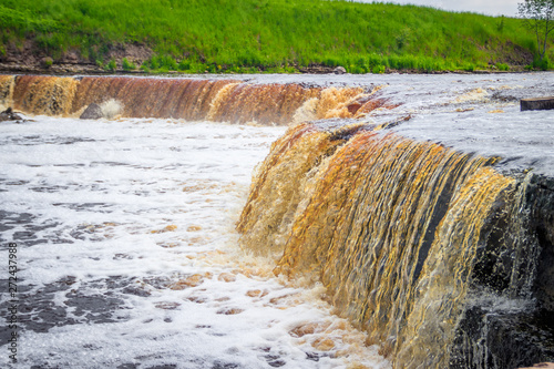 Sablinsky waterfalls. Little waterfall. The brown water of the waterfall.. Thresholds on the river. Strong water flow. Jets of water. Fast current photo