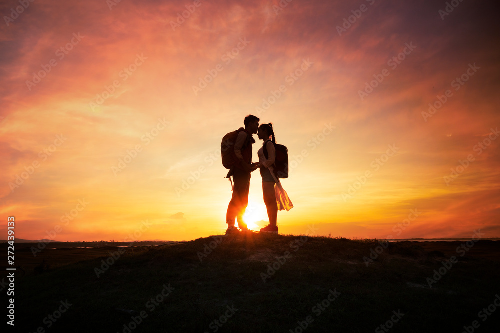 Silhouette romantic couple with sunset or sunrise background
