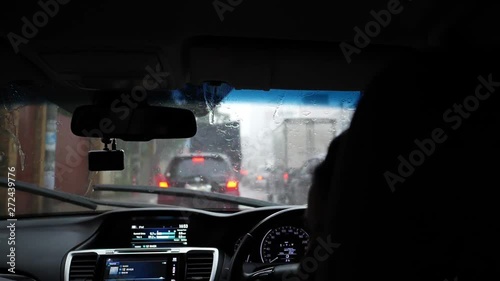 slow motion scene, people driving car, traffic jam on road town in rainy day