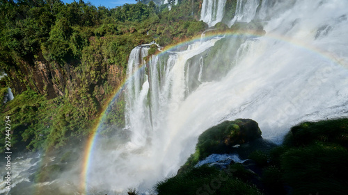 Iguazu Falls and a round rainbow on the Iguacu River. Located between Argentina and Brazil. Largest waterfalls system in the world.