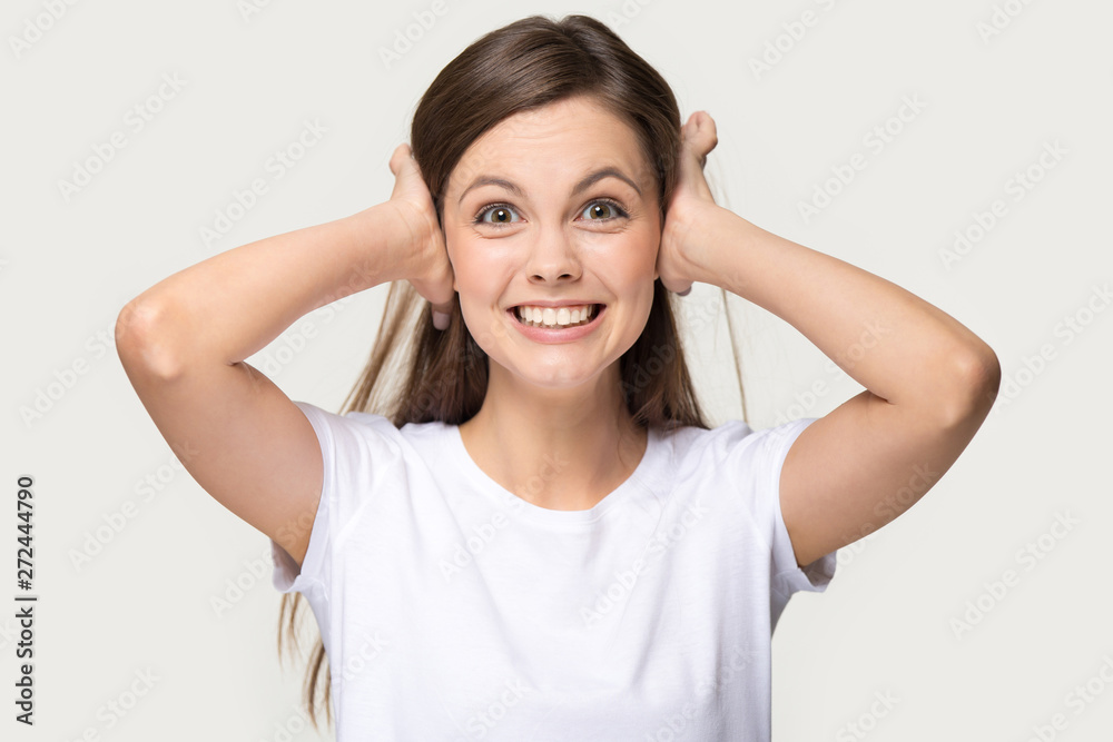 Irritated woman shut her ears with hands studio shot Irritated woman shut her ears with hands studio shot