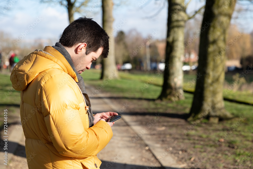 Man in winter in phone