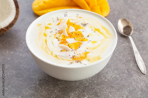 Mango smoothies bowl with coconut and Chia seeds. Vegan diet food concept. Healthy breakfast. 