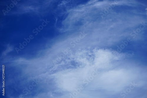 Brilliant Blue Sky with Clouds and the Moon