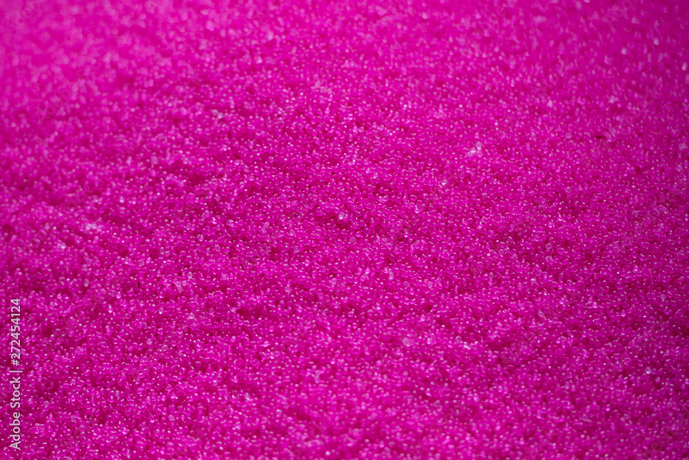 Close-up scene the  pile of pink raw plastic materials. The pellet of the thermoplastic material for injection process.
