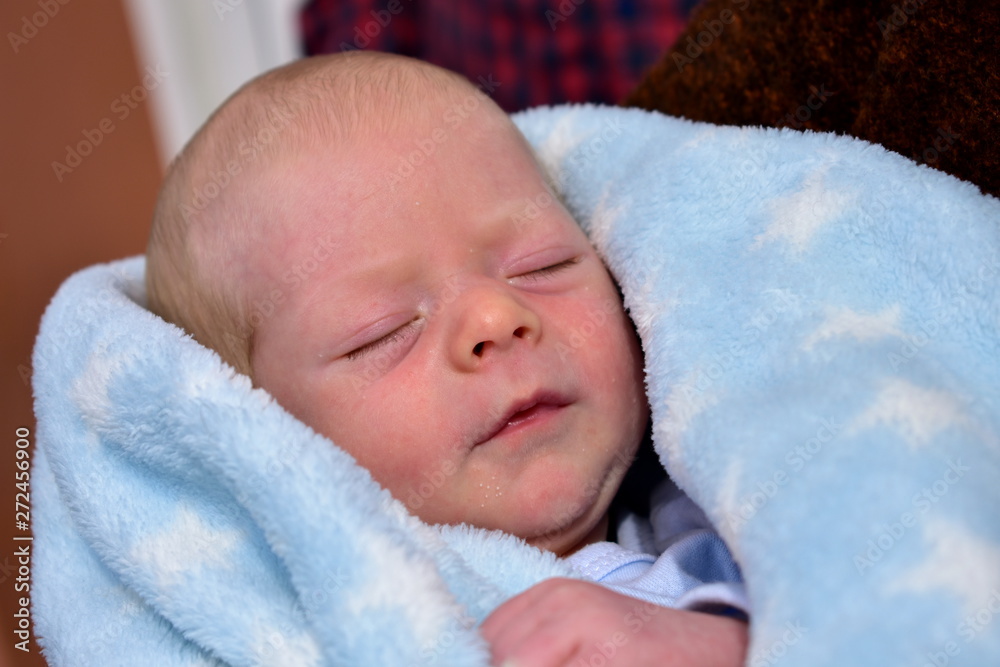 Newborn baby with a blue blanket. Blonde boy. Newborn baby with a blue blanket. Blonde boy.