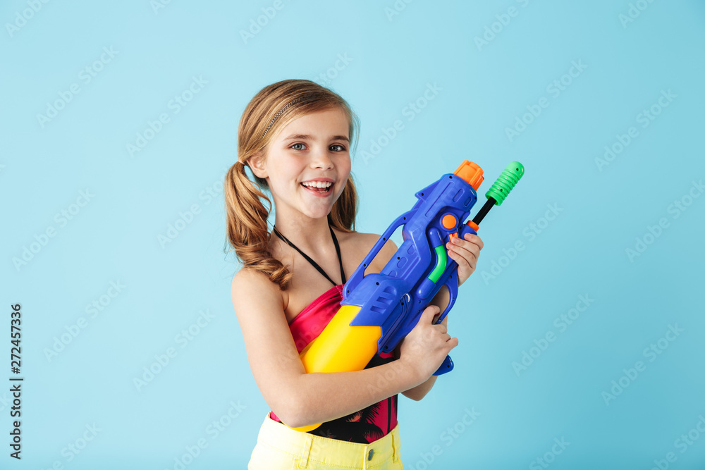 Cheerful little girl wearing swimsuit standing isolated Cheerful little girl wearing swimsuit standing isolated