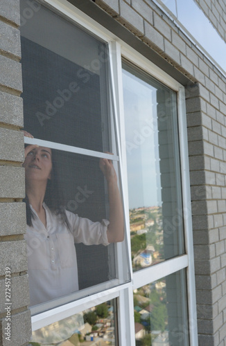 young woman behind the mosquito net
