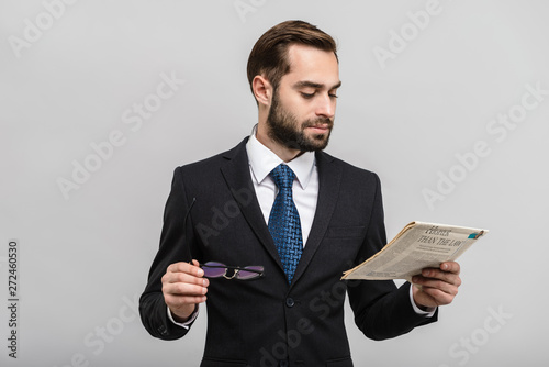 Handsome confident businessman wearing suit standing