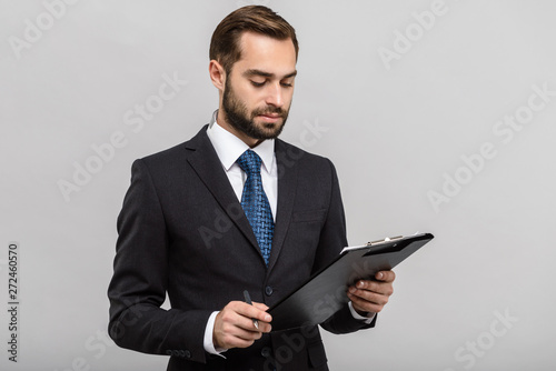 Handsome confident businessman wearing suit standing