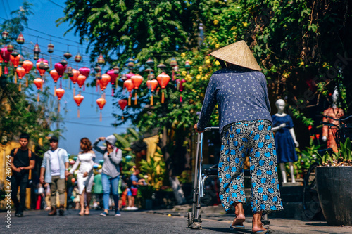 Old Lady Walking on the Streets of Hoi An, Vietnam