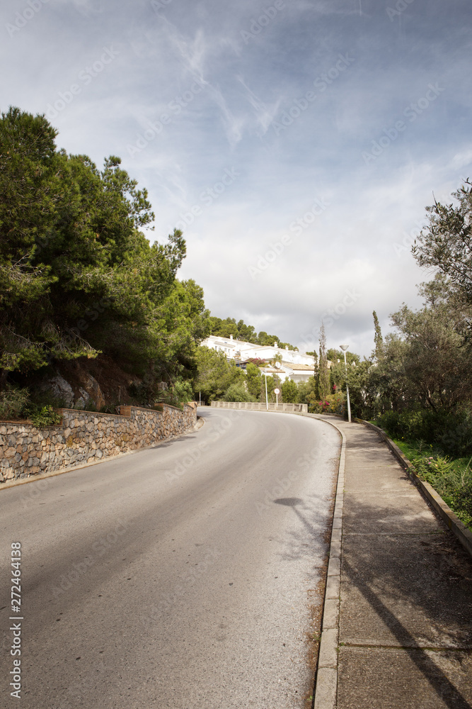 empty road on a hill side in spain