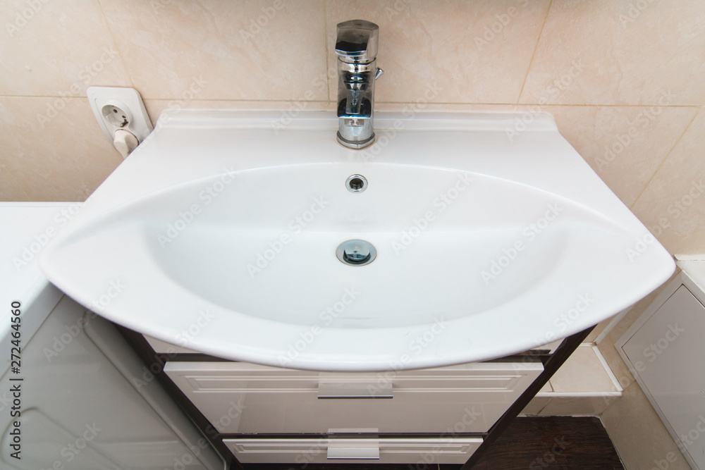 The photo of a sink in a bathroom The photo of a sink in a bathroom
