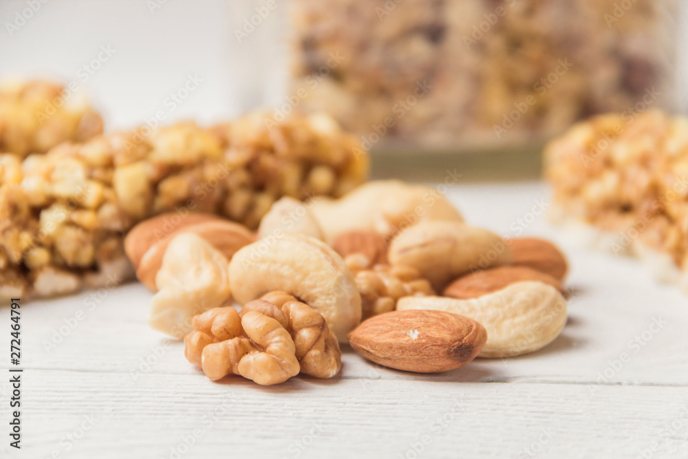 Assortment of nuts on white wooden table. Cashew, hazelnuts, walnuts, almonds.