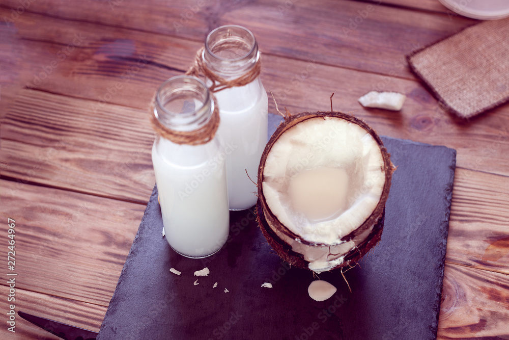 coconut and two bottles of coconut milk coconut and two bottles of coconut milk