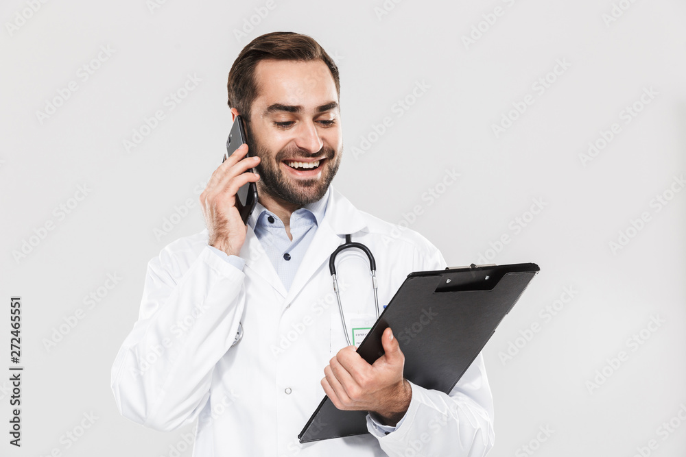 Attractive young cheerful male doctor wearing unifrom Attractive young cheerful male doctor wearing unifrom