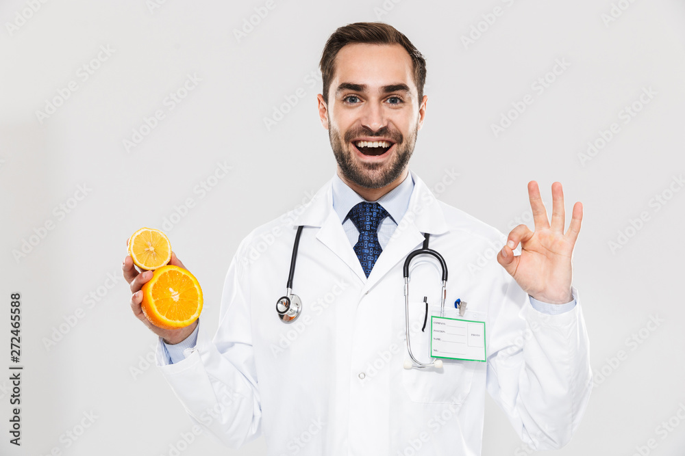 Attractive young cheerful male doctor wearing unifrom Attractive young cheerful male doctor wearing unifrom