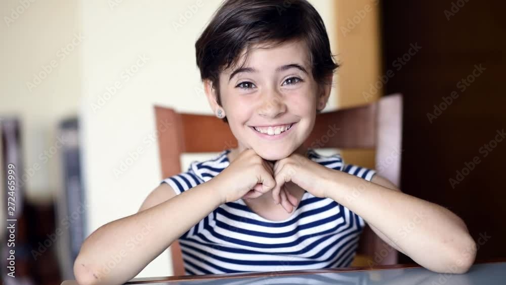 Funny eight-year-old girl putting different expressions to the camera indoors. Funny eight-year-old girl putting different expressions to the camera indoors.