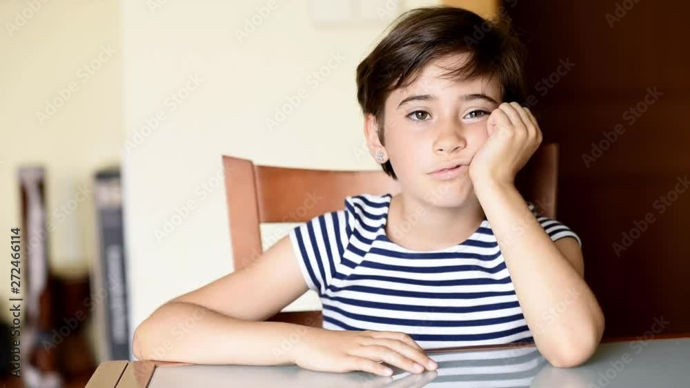 Funny eight-year-old girl putting different expressions to the camera indoors. Funny eight-year-old girl putting different expressions to the camera indoors.