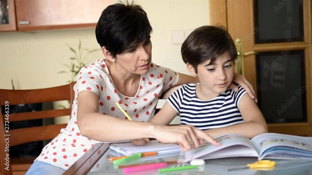 Middle-aged mother helps her daughter with her homework. Middle-aged mother helps her daughter with her homework.