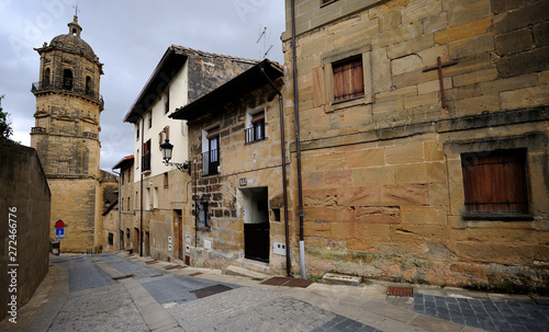 Labastida  Alava  Basque Country  Spain  06-29-2019  street of the medial or old helmet  paved floor and church is that of Our Lady of the Assumption